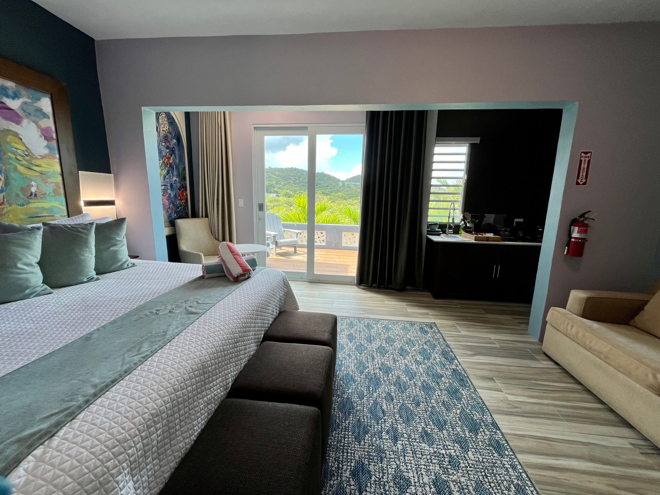King suite interior at Old Crow Hotel and Suites in Vieques Puerto Rico featuring a private balcony with rainforest views and full kitchen